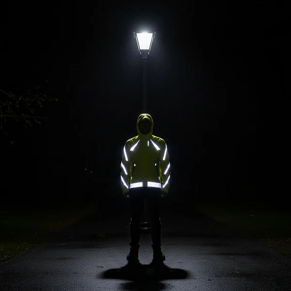 Reflective waterproof jacket glowing under a streetlight