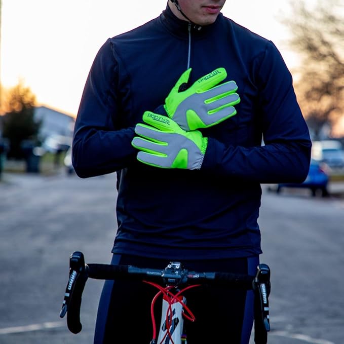 Man on bicycle at dusk in neon yellow reflective winter thermal cycling gloves adjusting gloves
