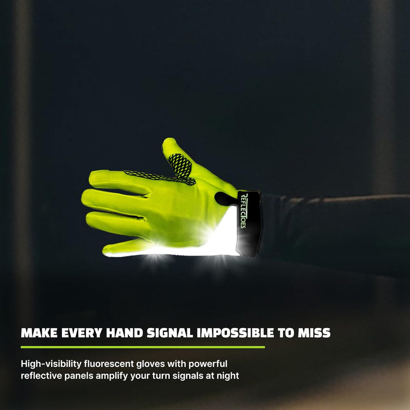 Neon yellow cycling glove raised in hand signal at night with bright reflective wrist strip glowing