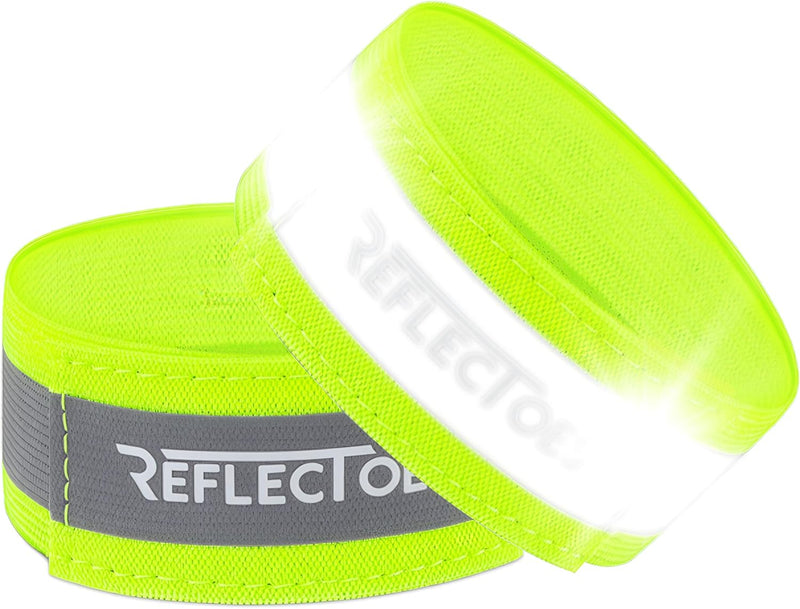 Two neon yellow ReflecToes reflective safety bands with silver retroreflective strip on white