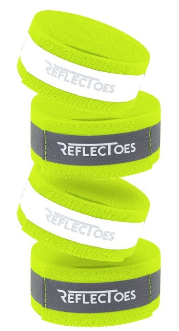 Four neon yellow ReflecToes reflective safety bands stacked on white background