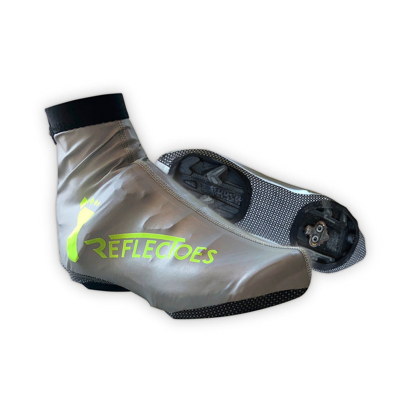 Pair of silver reflective cycling shoe covers with neon yellow logo and cleats on white background